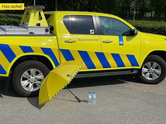 auto met paraplu en flesje water