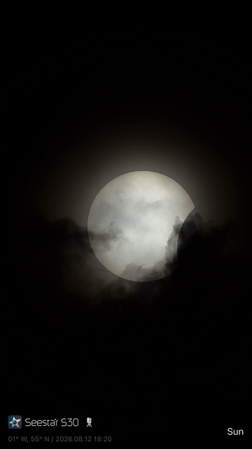 A white image of the Sun courtesy of Baader Solar Astrofilm filter on the Seestar S30 telescope. The moon is just starting to cover the Sun at the right