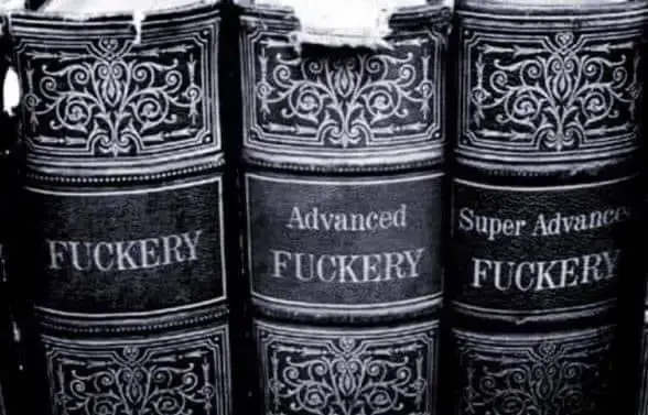 Black and white photo of the spines of three old-style books entitled FUCKERY, Advanced FUCKERY, and Super Advanced FUCKERY