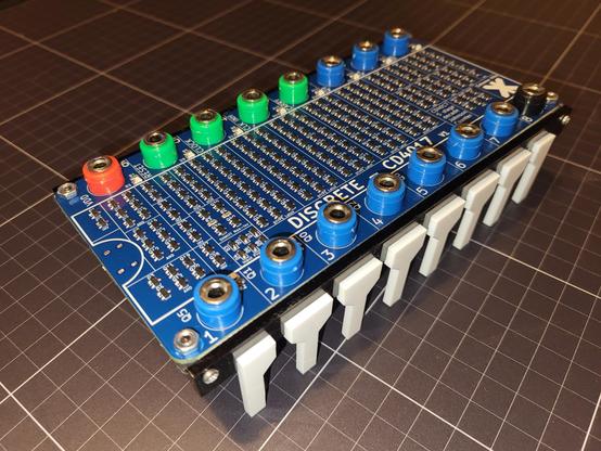 Large blue pcb with a lot of transiators. And black and white acrylic legs. 16 multi coloured banana sockets.
A discrete-4017