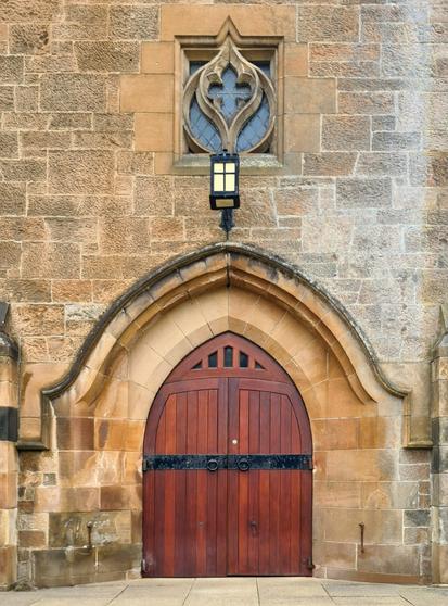 A gothic-arched door and doorway on a late Victorian church in Glasgow.