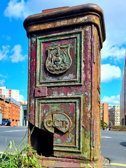 A battered metal box on a Glasgow street with a cartouche with the letters G.C.T. on it.