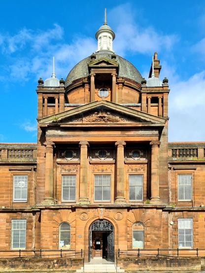 The main facade od a Victorian town hall, featuring Beaux Arts style domes and Classical style elements.