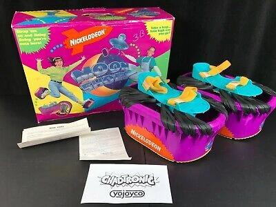 Box, and two moon shoes with directions. They have bright colors and the shoes are made like a trampoline. Bouncy Shoes