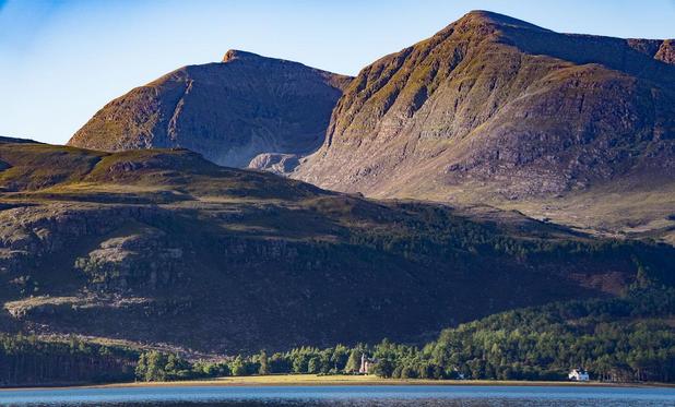 Mountain by a blue loch.