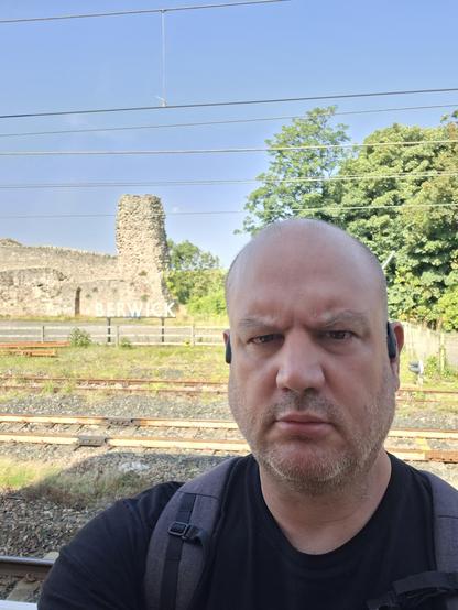 Me, standing on the platform at Berwick, not looking happy about it even though I'm quite cheerful inside.  I guess this is just my face now.