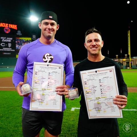 A picture of Carson Seymour and Nate Furman with their balls from their first career save and first career hit, respectively