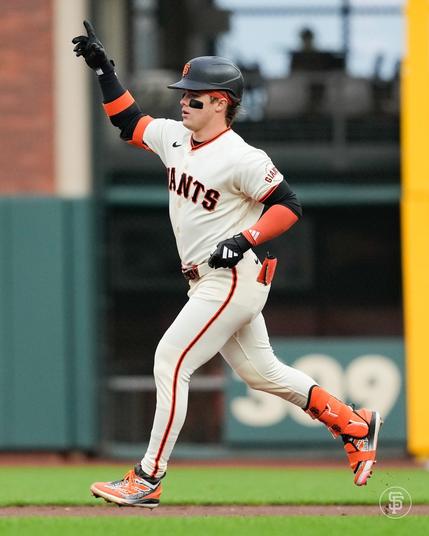 Gilbert points at the bullpen as he rounds the bases