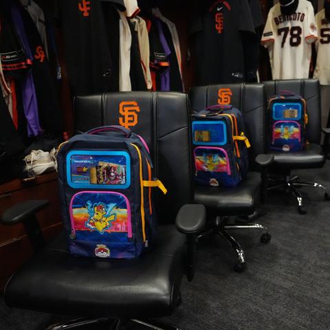 The Pokemon Worlds backpacks on chairs in the SFGiants clubhouse