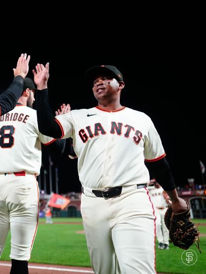 Rafael Devers high fives his teammates after the win