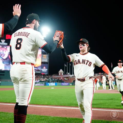 Drew Gilbet high fives his teammates after the win