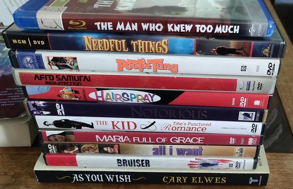 A Blu Ray movie and nine DVD movies, plus a book