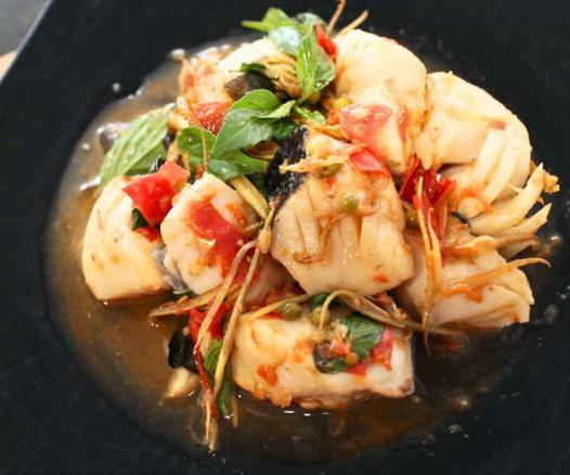 Stir fried fish in a brown sauce with herbs