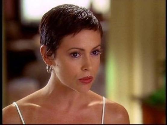 alyssa milano as phoebe halliwell with gold hoops and white straps with a perfect pixie cut