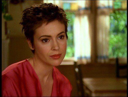 alyssa milano as phoebe halliwell with a red robe with a perfect pixie cut