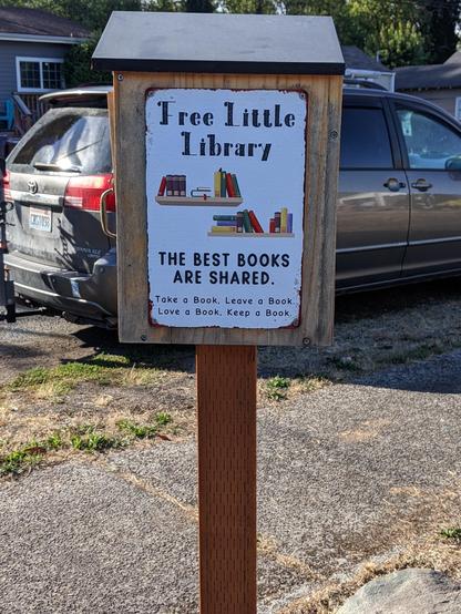 "Free Little Library" box on a post, side view.