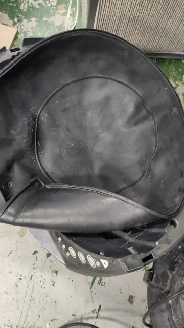 A black rubber membrane like a deflated exercise ball, it has claw marks and it smells like very old cat shit