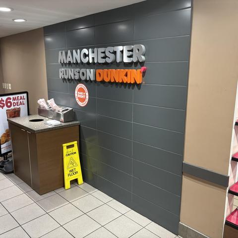 On the wall it says "Manchester Runs on Dunkin'"
