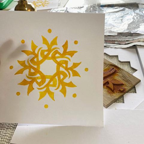 A finished print just off the plate, which can be seen in a jig in the background.