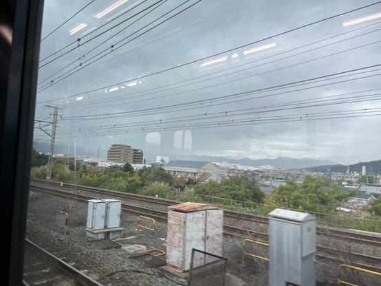 Looking out the train window near Odawara, misty mountain in the background