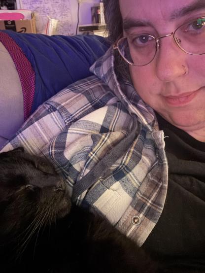Close up selfie of me and my sleeping black cat who is making this difficult to type