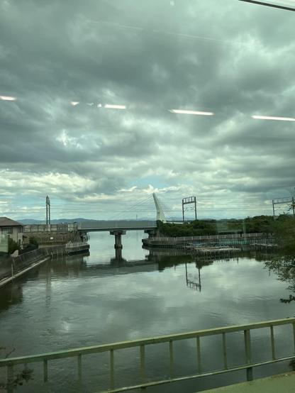 Hamamatsu lake reflecting the moody sky with a bridge in the center