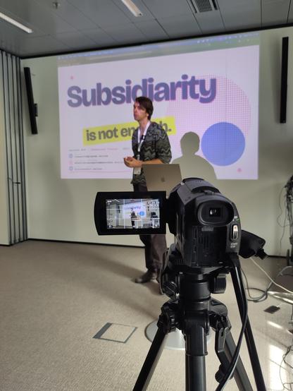 Laurens is giving His Talk at oscl26  - a camera ist filming him