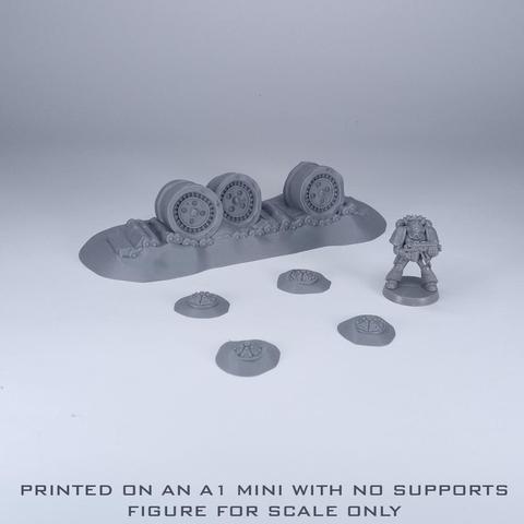 Some ruined tank tracks and some mines with a figure next to them