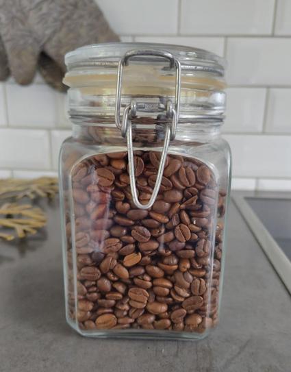 A glass jar reassuringly full of coffee beans.