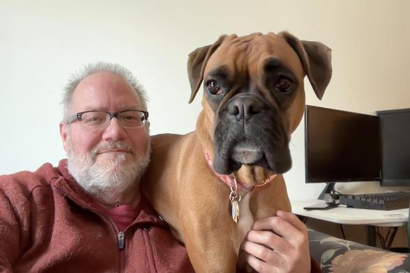 an older man and a boxer dog