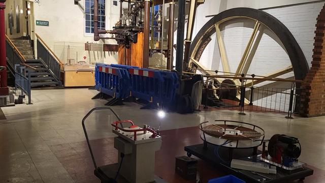 Electrical jacobs ladder with a steam engine in the backgound