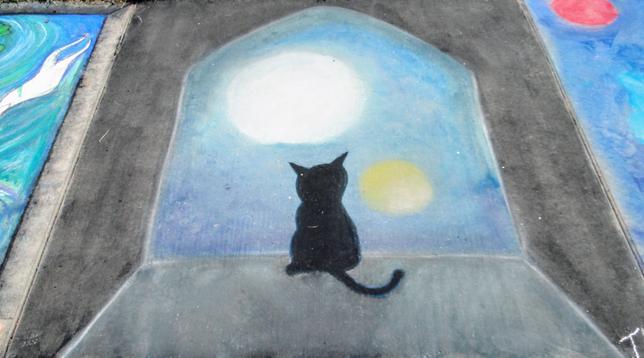 A chalk drawing of a black kitty looking at the Moon