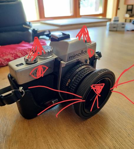 A picture of a Minolta SR-T 100X with a cat face drawn on it