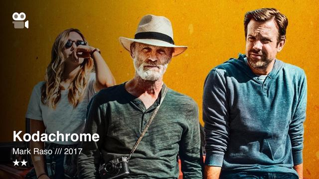 Three people against a yellow wall: woman in sunglasses, bearded man in hat with camera, man in blue; “Kodachrome” text.