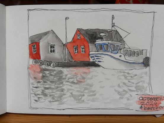 Boat snuggled up to some red barns