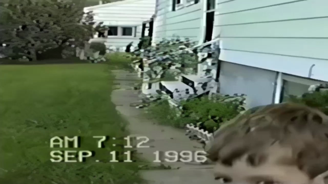 A 1996 VHS recording with a fair amount of distortion. My mother is recording flowers, but sees me come into frame. She encourages me to step over for a shot, but I turn and scream at a bee and run off.