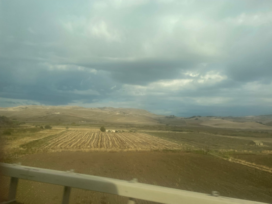 brown fields and clouds.