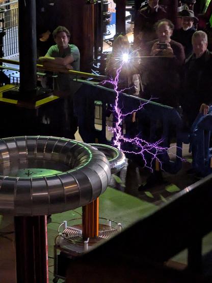 Big purple lightning coming off of a solid state Tesla coil