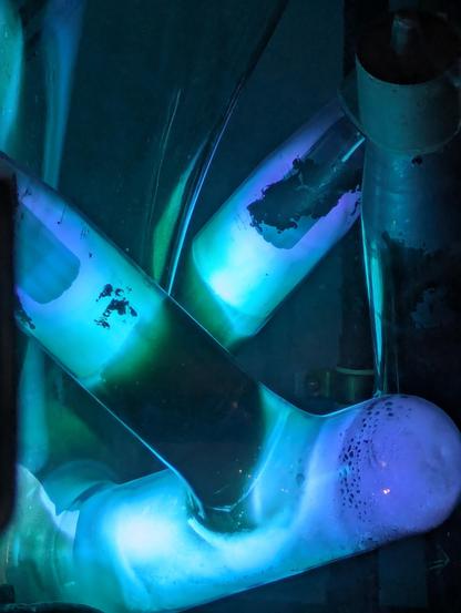 One part of the Mercury Rectifier with purpleish greenish light in some glass tubes