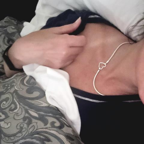 Wallflower's neck with necklace, in bed