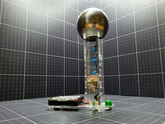 A  175mm tall, high voltage generator that will achieve 30,000 to 40,000 volts of "static" electricity. With no mechanical parts. The Cockcroft Walton Multiplier is a safe, current limited high voltage generator for home lab or classroom. It is capable of providing the high voltage for all the experiments that can be done with the 150mm Van De Graaff, but as there is no reliance on triboelectric charging it does not require the low humidity and scrupulous cleanliness and so removes many of the problems associated with traditional Van de Graffs.

Unusually for a Cockcroft Walton Multiplier the high voltage is delivered to a small Van de Graaff dome to ease its use with experiments intended for a classic VDG