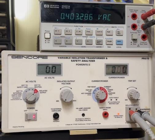 A photo of a Sencore PR570 under an HP 34401 6.5 digit meter. The PR570 is reading 24V, and the HP is reading 25.5.