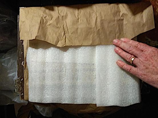 The book wrapped with protective plastic and then brown paper