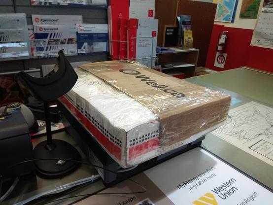 The package is weighed at the post office
