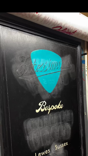 Painting and gilding the sign for Fitzsimmons