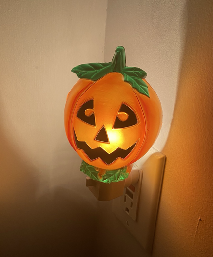A nightlight in the form of a jack-o-lantern.