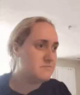 a close up of a woman 's face with a black shirt on