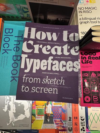 Among other books on a table, the new and revised edition of How to create typefaces from sketch to screen by Cristóbal Henestrosa, Laura Meseguer, and José Scaglione.