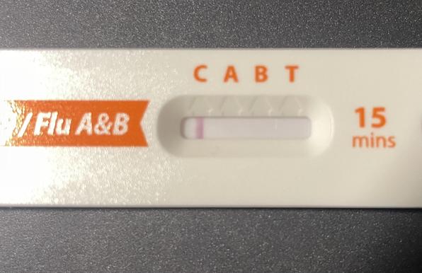 Picture of a test for Covid and flu A & B. The test strip has 4 marked spots for lines to appear, marked with letters C A B & T. There is a line at the C spot and happily that’s the only line.