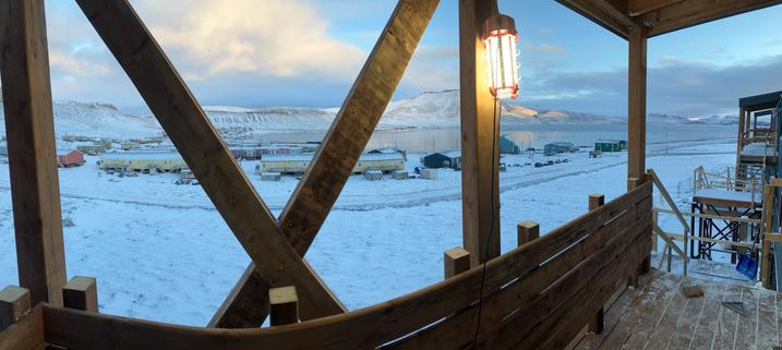 Panorama from an apartment landing under construction. Overlooking a small Inuit community wrapped around a bay that is trying to freeze.